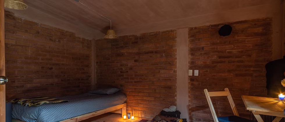 A dark, candlelit room prepared for darkness practice